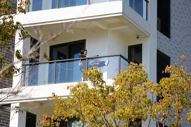 An elderly woman exercises in her balcony, at a nursing home of Lendlease's Ardor Gardens in Shanghai