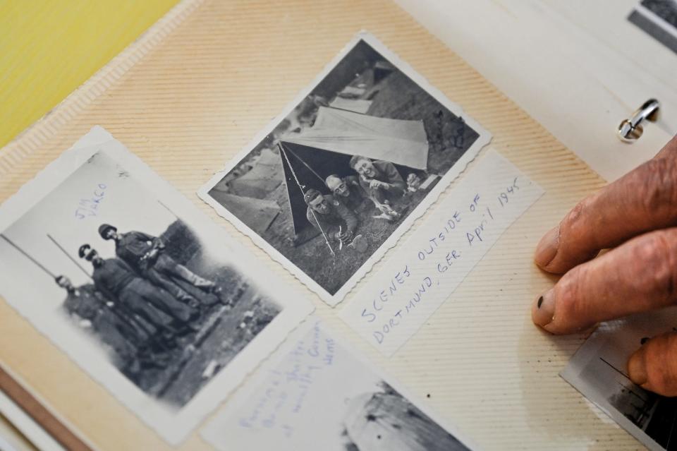 Robert Vondale, 97, looks at photos from 1945 during his time in the service on Monday, July 18, 2022, at his home in Grand Ledge. Vondale is one of the few surviving members of the World War II U.S. Army Ranger battalions. Last month President Biden signed an order to award rangers the Congressional Gold Medal.