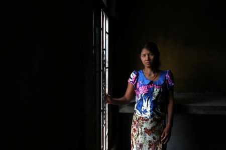 Phyu Phyu, 48, who says she was dragged to a railway and beaten up by her husband, and is currently seeking help at a women's support group, is pictured in Shwelaung, Ayeyarwady