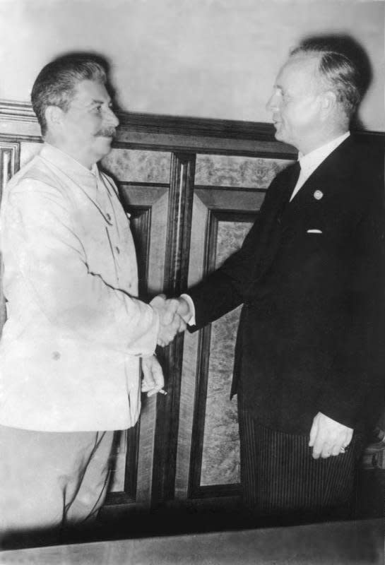 Soviet leader Joseph Stalin (L) and German Foreign Minister Joachim von Ribbentrop shake hands after signing the Molotov-Ribbentrop Pact on August 23, 1939. File Photo courtesy of the German Federal Archive