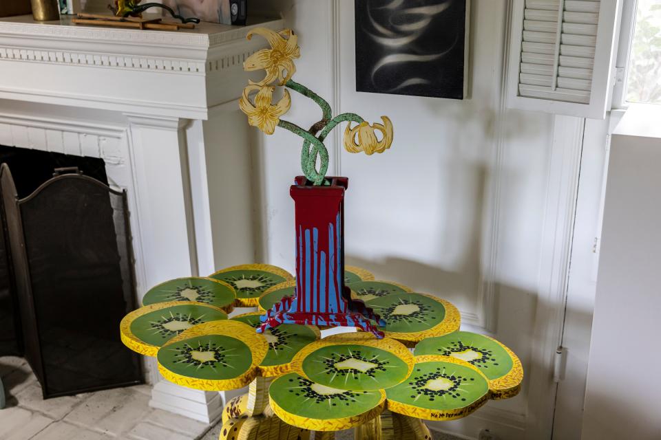 A table with open kiwi fruit painted on it.