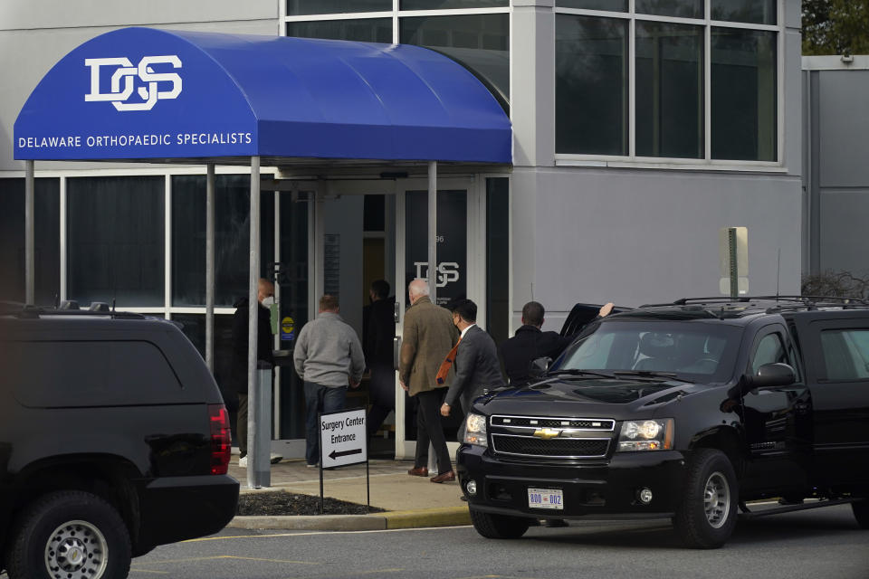 President Joe Biden, center, steps out of a motorcade vehicle as he arrives for an orthopaedic appointment, Saturday, Feb. 6, 2021, in Newark, Del. Biden fractured his right foot while playing with one of his dogs in November. (AP Photo/Patrick Semansky)