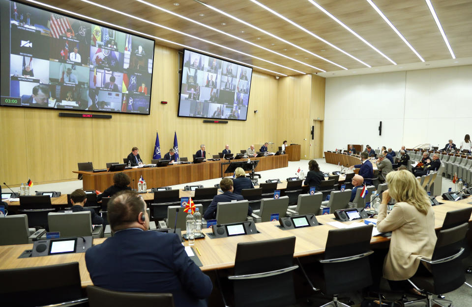 NATO Secretary General Jens Stoltenberg, back row center, speaks during a video conference of NATO Defense Minister at the NATO headquarters in Brussels, Wednesday, June 17, 2020. NATO Defense Ministers begin two days of video talks focused on deterring Russian aggression and a US decision to withdraw thousands of troops from Germany. (Francois Lenoir, Pool Photo via AP)