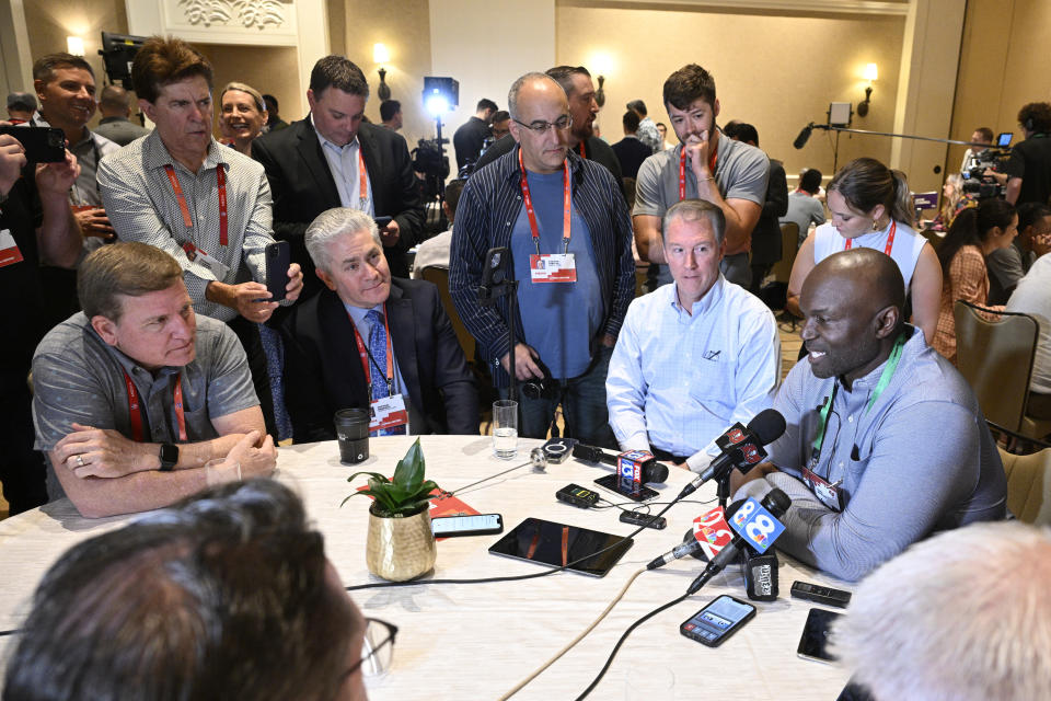 Tampa Bay Buccaneers head football coach Todd Bowles, right, talks with reporters during an NFC coaches availability at the NFL owners meetings, Tuesday, March 26, 2024, in Orlando, Fla. (AP Photo/Phelan M. Ebenhack)