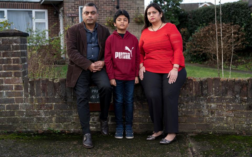 Postmistress Seema Misra, above, with her family in Surrey