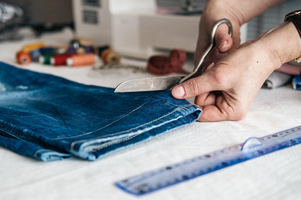 person trims jean pants