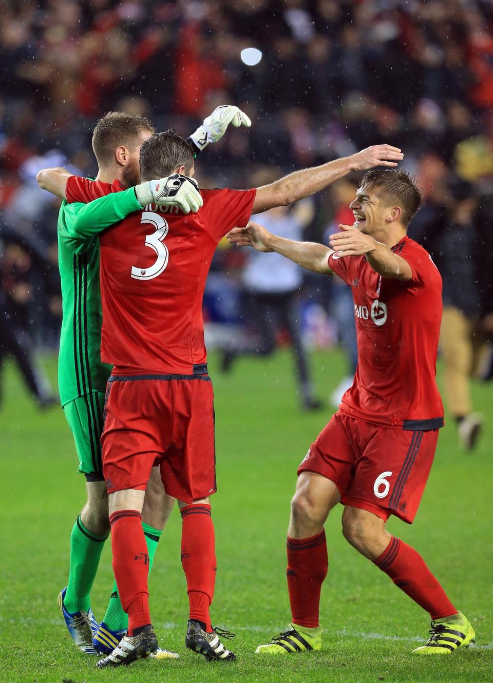 <p>Drew Moor #3 of Toronto FC celebrates with Clint Irwin #1 and Nick Hagglund #6 at the final whistle following the MLS Eastern Conference Final, Leg 2 game against Montreal Impact at BMO Field on November 30, 2016 in Toronto, Ontario, Canada. (Photo by Vaughn Ridley/Getty Images) </p>