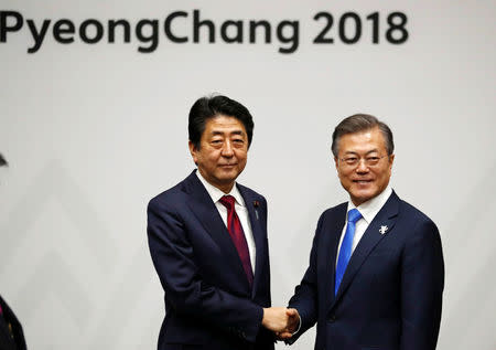 South Korean President Moon Jae-in shakes hands with Japanese Prime Minister Shinzo Abe during their meeting in Pyeongchang, South Korea February 9, 2018. REUTERS/Kim Hong-Ji
