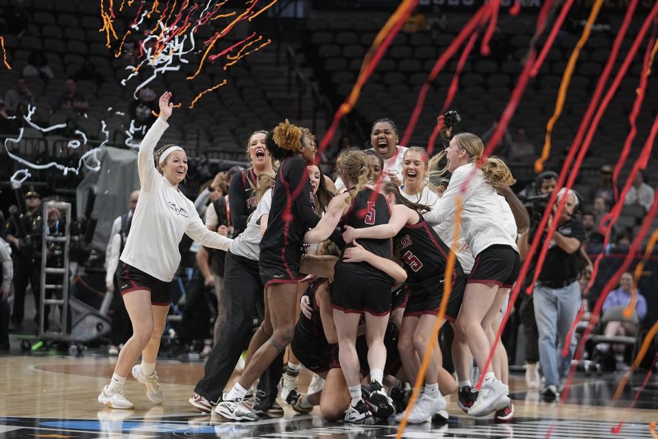 Transylvania players celebrate after winning the NCAA Women's Division 3 championship basketball game against Christopher Newport Saturday, April 1, 2023, in Dallas. (AP Photo/Darron Cummings)