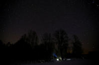 The hut where Tamara and Yuri Baikov, both 69, live, is seen under night stars in a forest near the village of Yukhovichi, Belarus, February 7, 2018. REUTERS/Vasily Fedosenko