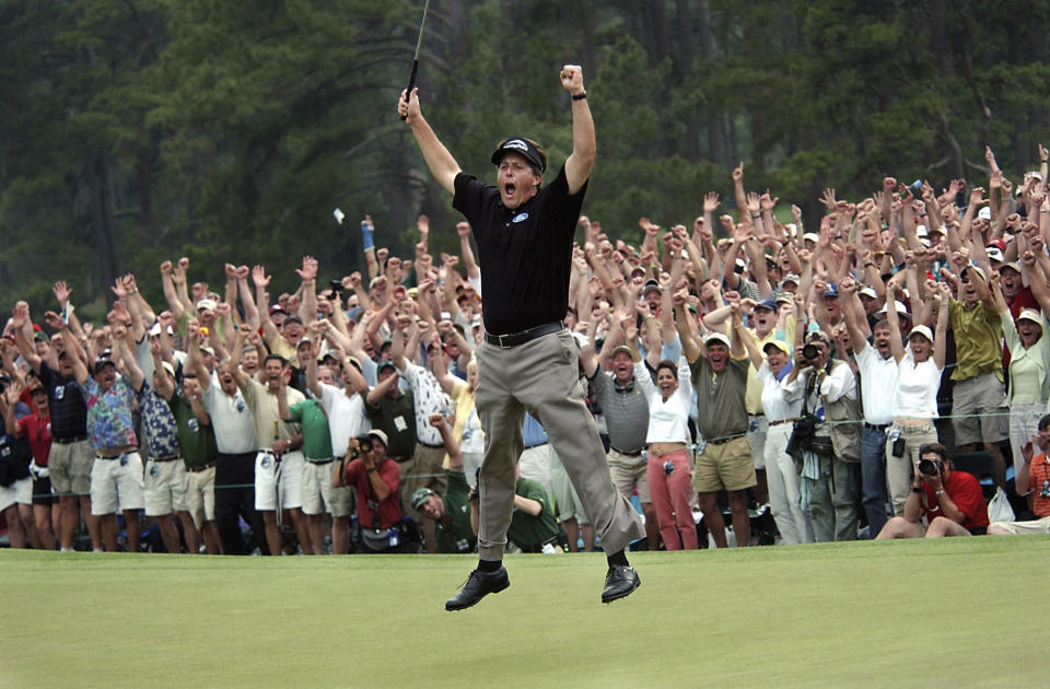 FILE - Phil Mickelson celebrates after winning the Masters golf tournament with a nine-under-par at the Augusta National Golf Club in Augusta, Ga., April 11, 2004. This is the 20-year anniversary of his first major. (AP Photo/Dave Martin, File)