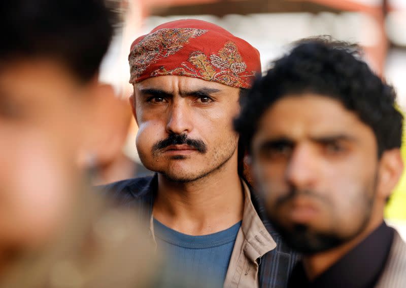 People chew qat, a mild stimulant, at a fruit market amid concerns of the spread of the coronavirus disease (COVID-19) in Sanaa