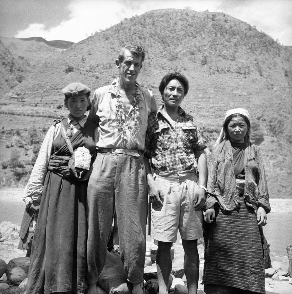 Edmund Hillary, second from left, of the British Everest Expedition, who with the Sherpa Tensing, third from left, was the first to make the ascent of the peak stands with two of Tensing's nieces, Droma, left, and Phulima far right, who climbed with the expedition to 23,000-feet at Dhullal Ghat, Nepal, after the returning party had descended from Namche Bazar on June 19, 1953.