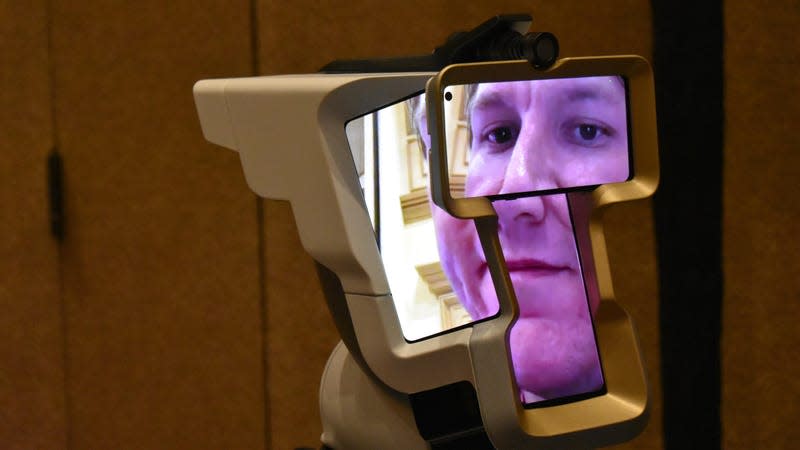 A device with four screens showing multiple parts of a persons' face.