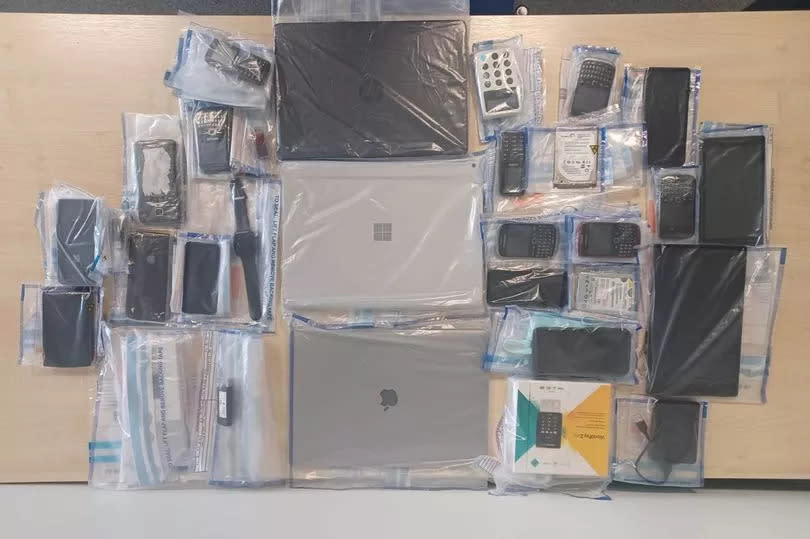 Items seized by the Metropolitan Police after raids on a website being used to defraud thousands