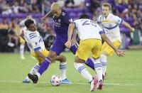 Orlando player Junior Urso, center, controls the ball among San Jose players during a MSL soccer match in Orlando, Fla., on Tuesday, June 22, 2021. (Stephen M. Dowell /Orlando Sentinel via AP)