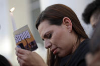 <p>Kristin Alexander holds a candle during a vigil at City Hall in Las Vegas, Monday, Oct. 2, 2017. The vigil was held in honor of the over 50 people killed and hundreds injured in a mass shooting at an outdoor music concert late Sunday. (Photo: Gregory Bull/AP) </p>