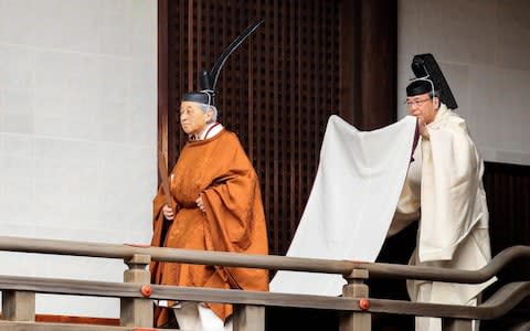 Emperor Akihito walks to the Kasukodokoro, one of the Imperial Sanctuaries for the 'Taiirei Tojitsu Kashikodokoro Omae no Gi' ceremony  - Credit: The Asahi Shimbun via Getty Images