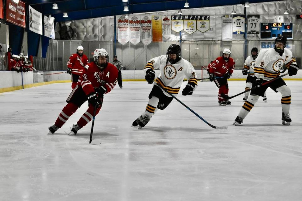 West Allegheny's Pasquale Hively tries to skate past Quaker Valley's Will Watson as QV's Ben Carlson watches.