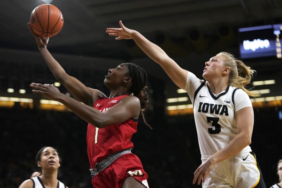 Maryland guard Diamond Miller (1) drives to the basket past Iowa guard Sydney Affolter (3) during the first half of an NCAA college basketball game, Thursday, Feb. 2, 2023, in Iowa City, Iowa. (AP Photo/Charlie Neibergall)