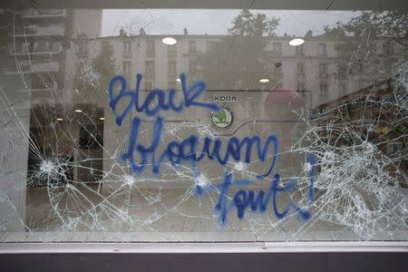 A message is written on the window of an auto dealership which was attacked by youths who took part in a demonstration in protest of the government's proposed labour law reforms in Paris, France, May 26, 2016. REUTERS/Charles Platiau