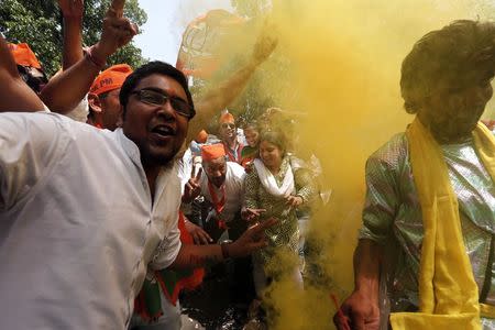 Supporters of the India's Bharatiya Janata Party (BJP) celebrate after learning of the initial poll results outside the party headquarters in New Delhi May 16, 2014. REUTERS/Adnan Abidi