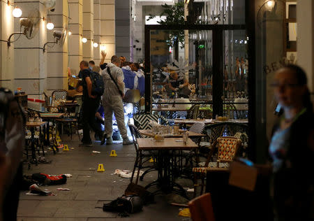 Israeli policemen work inside a restaurant following a shooting attack that took place in the center of Tel Aviv June 8, 2016. REUTERS/Baz Ratner/Files