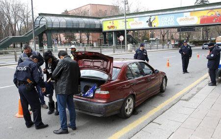 Police officers search a car during a security control check in central Ankara, Turkey March 20, 2016. REUTERS/Umit Bektas