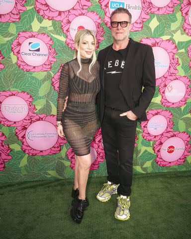 <p>Andrew J Cunningham/Getty</p> Tori Spelling (left) posing with husband Dean McDermott (right) in June 2023.