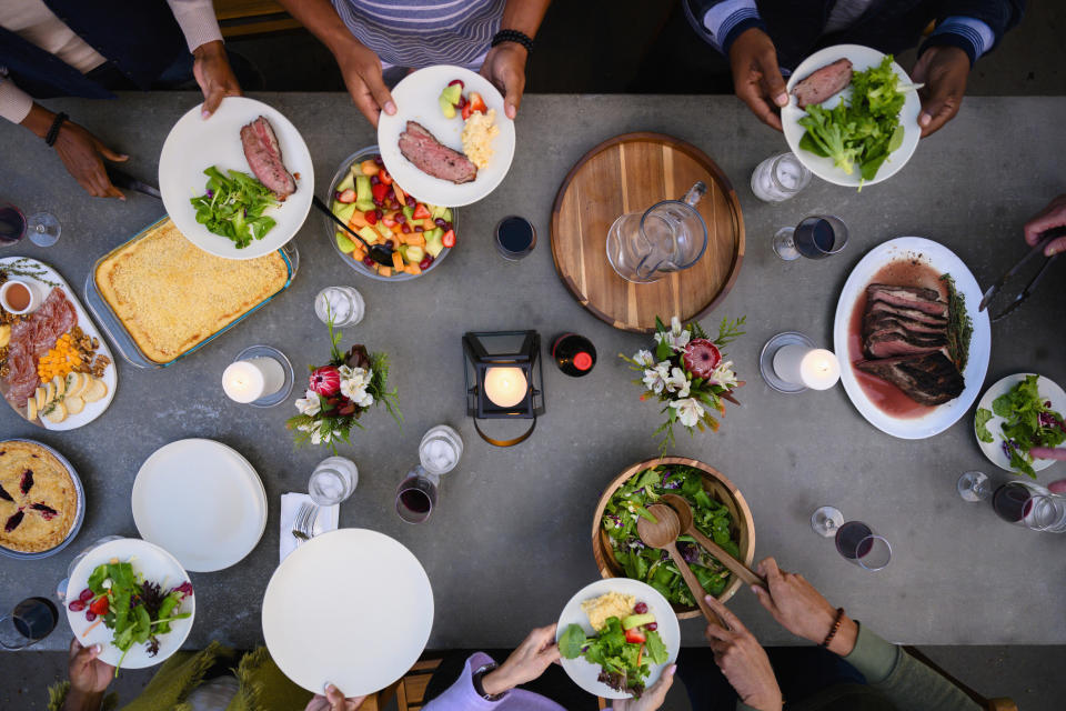 dining table with people placing food on their plates