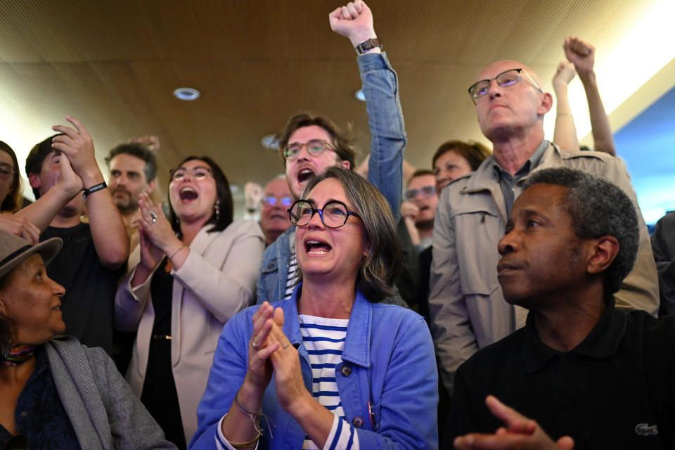 Supporters of the left wing coalition Nouveau Front Populaire (NFP) react after the first results of the second round of France's legislative election during an election night event in Rennes on July 7, 2024.