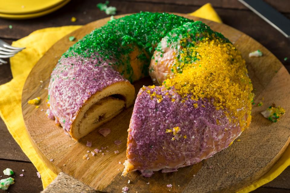 A traditional Louisiana king cake comes dressed in the colors of Mardi Gras: purple, green and yellow.