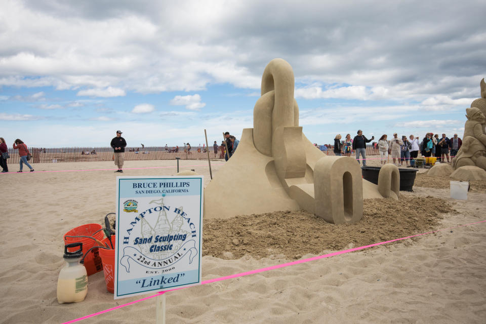 Bruce Phillips, of San Diego, California, with his piece "Linked" at the 2022 Hampton Beach Master Sand Sculpting Classic Saturday, June 18.