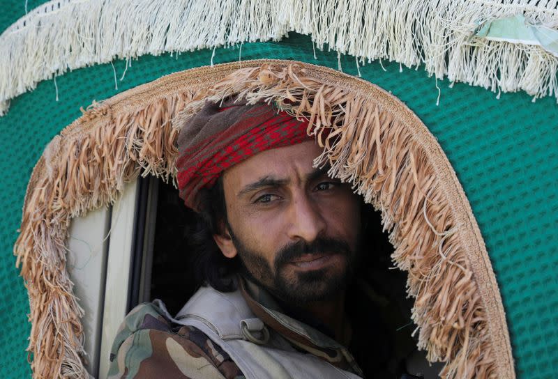 FILE PHOTO: A Houthi follower looks out the window of a vehicle carrying the coffin of a Houthi fighter, killed in recent fighting against government forces in Yemen's oil-rich province of Marib