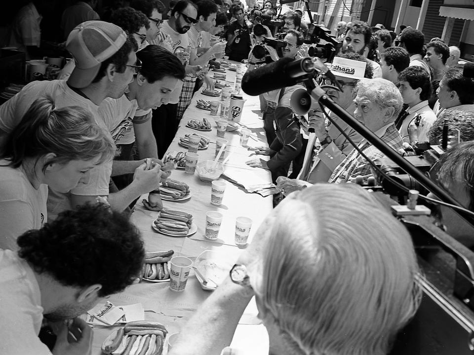 Contestants eat hot dogs during the 1987 Nathan's Hot Dog Eating Contest at Coney Island