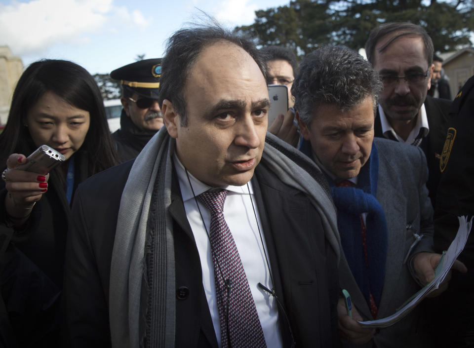 Monzer Akbik, center, a Syrian opposition spokesman, leaves after a short press briefing at the United Nations headquarters in Geneva, Switzerland, Switzerland, Monday, Jan. 27, 2014. Akbik said the coalition was still determined to stay for the political talks set to begin Monday despite accusing the government of stalling. (AP Photo/Anja Niedringhaus)