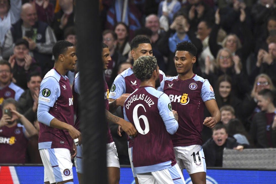 Aston Villa's Ollie Watkins, right, celebrates after scoring his side's opening goal during the Europa Conference League quarter final first leg soccer match between Aston Villa and Lille at Villa Park in Birmingham, England, Thursday, April 11, 2024. (AP Photo/Rui Vieira)