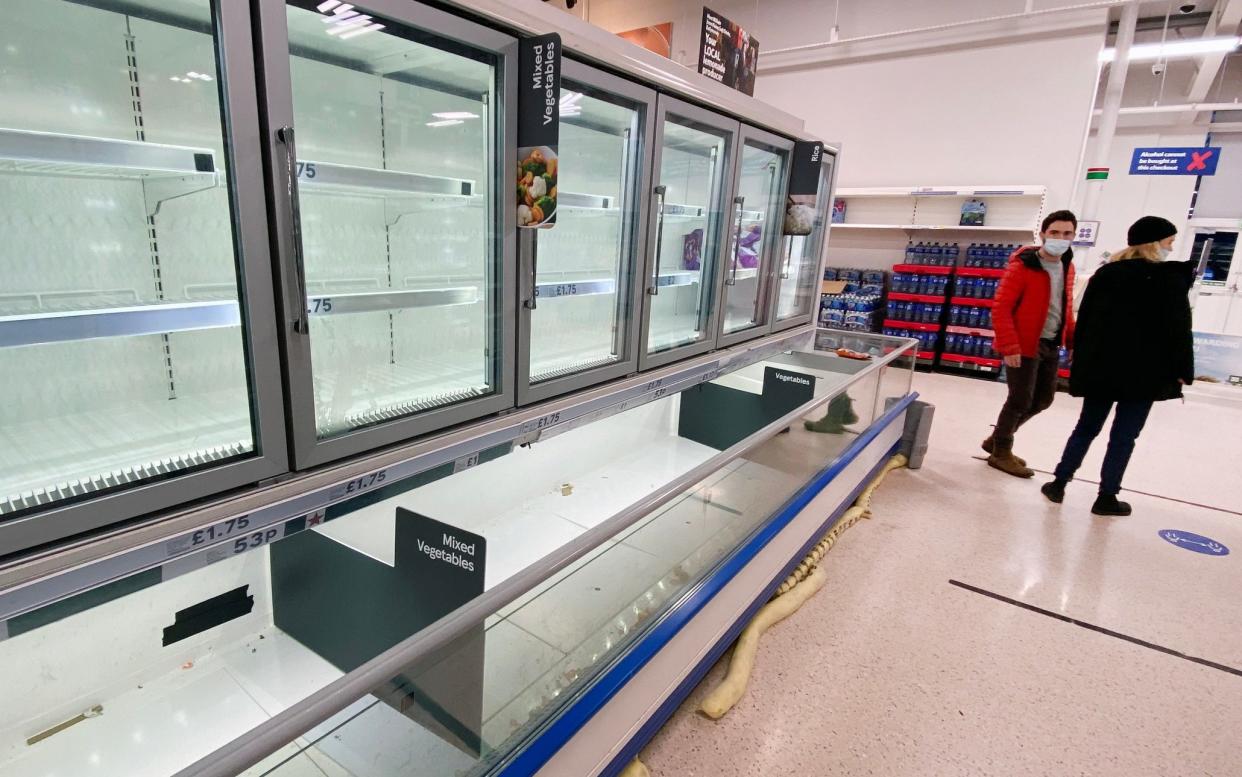 BELFAST, NORTHERN IRELAND - JANUARY 14: Supermarket shoppers in Tescos stare at a near empty freezer cabinet on January 14, 2021 in Belfast, Northern Ireland. Supermarkets here are already seeing disruption to food supplies after the end of the Brexit transition period on December 31st, when Northern Ireland remained part of the E.U. single market while GB left. The change will require food products entering NI from Great Britain to receive additional certification and checks at ports. Despite a three-month "grace period," in which supermarkets needn't comply with all EU certification requirements, shoppers are already seeing disruption as supermarkets grapple with the changes. (Photo by Charles McQuillan/Getty Images) - Charles McQuillan/ Getty Images