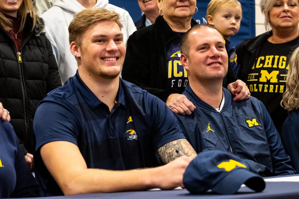 Port Huron Northern's Braiden McGregor (left) is seen with his family after signing his letter of intent to Michigan at Port Huron Northern High School on Wednesday, Dec. 18, 2019.