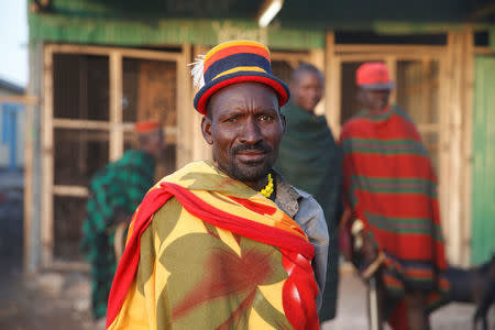 A Turkana man poses for a picture at a cattle market in Lodwar, in Turkana County, Kenya February 9, 2018. REUTERS/Baz Ratner