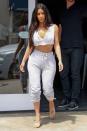 <p>In a white plunging crop top, gray drawstring sweatpants and Yeezy heels out in Sherman Oaks, California. </p>