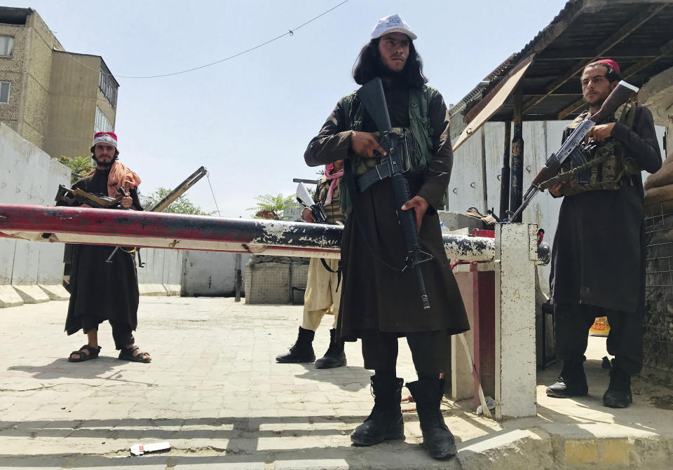 Taliban fighters stand guard at a checkpoint near the US embassy that was previously manned by American troops, in Kabul, Afghanistan, Tuesday, Aug. 17, 2021. The Taliban declared an "amnesty" across Afghanistan and urged women to join their government Tuesday, seeking to convince a wary population that they have changed a day after deadly chaos gripped the main airport as desperate crowds tried to flee the country. (AP Photo)