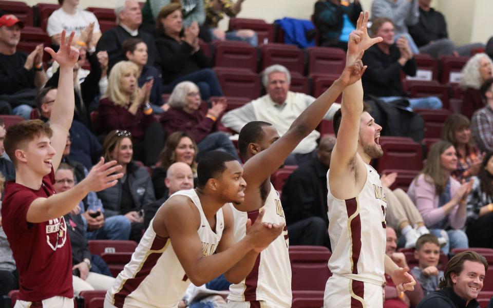 The Walsh bench reacts to a made 3-pointer against Findlay in a G-MAC Tournament semifinal, Friday, March 4, 2022.