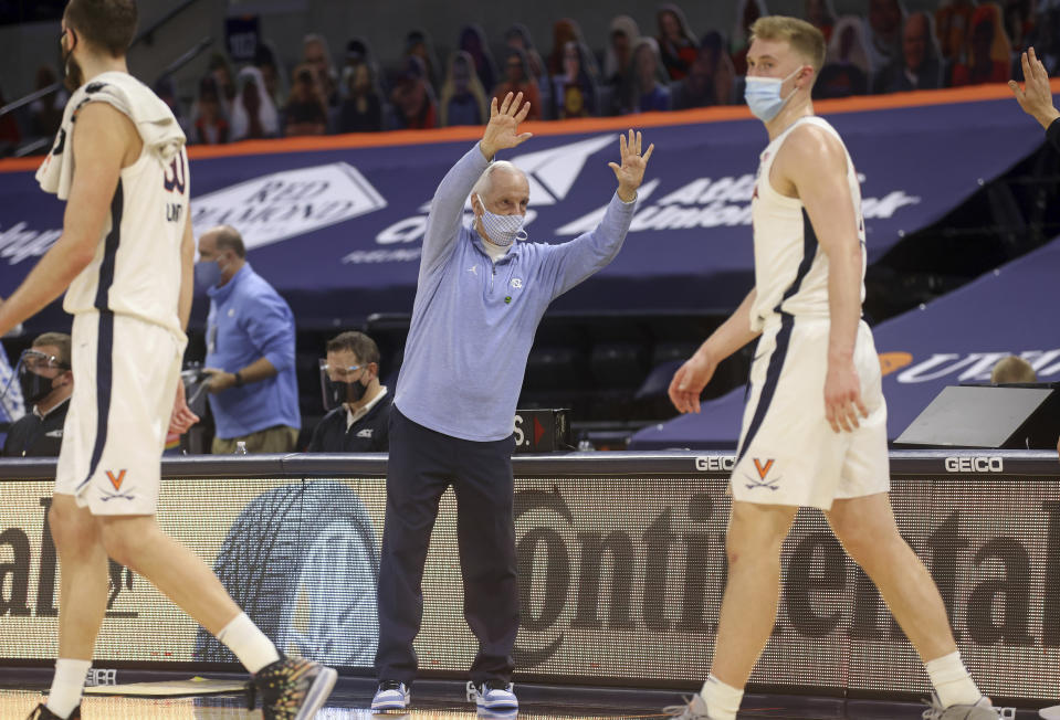 North Carolina coach Roy Williams waves goodbye to the Virginia coaching staff after an NCAA college basketball game Saturday, Feb. 13, 2021, in Charlottesville, Va. (Andrew Shurtleff/The Daily Progress via AP, Pool)