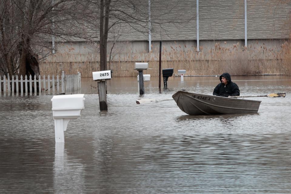 LAKE STATION, IN - FEBRUARY 22:  A resident uses a rowboat to navigate a flooded neighborhood on February 22, 2018 in Lake Station, Indiana. Heavy rains and snow melt have caused flooding in Indiana, Illinois, Michigan, Wisconsin and other Midwest states.  (Photo by Scott Olson/Getty Images)