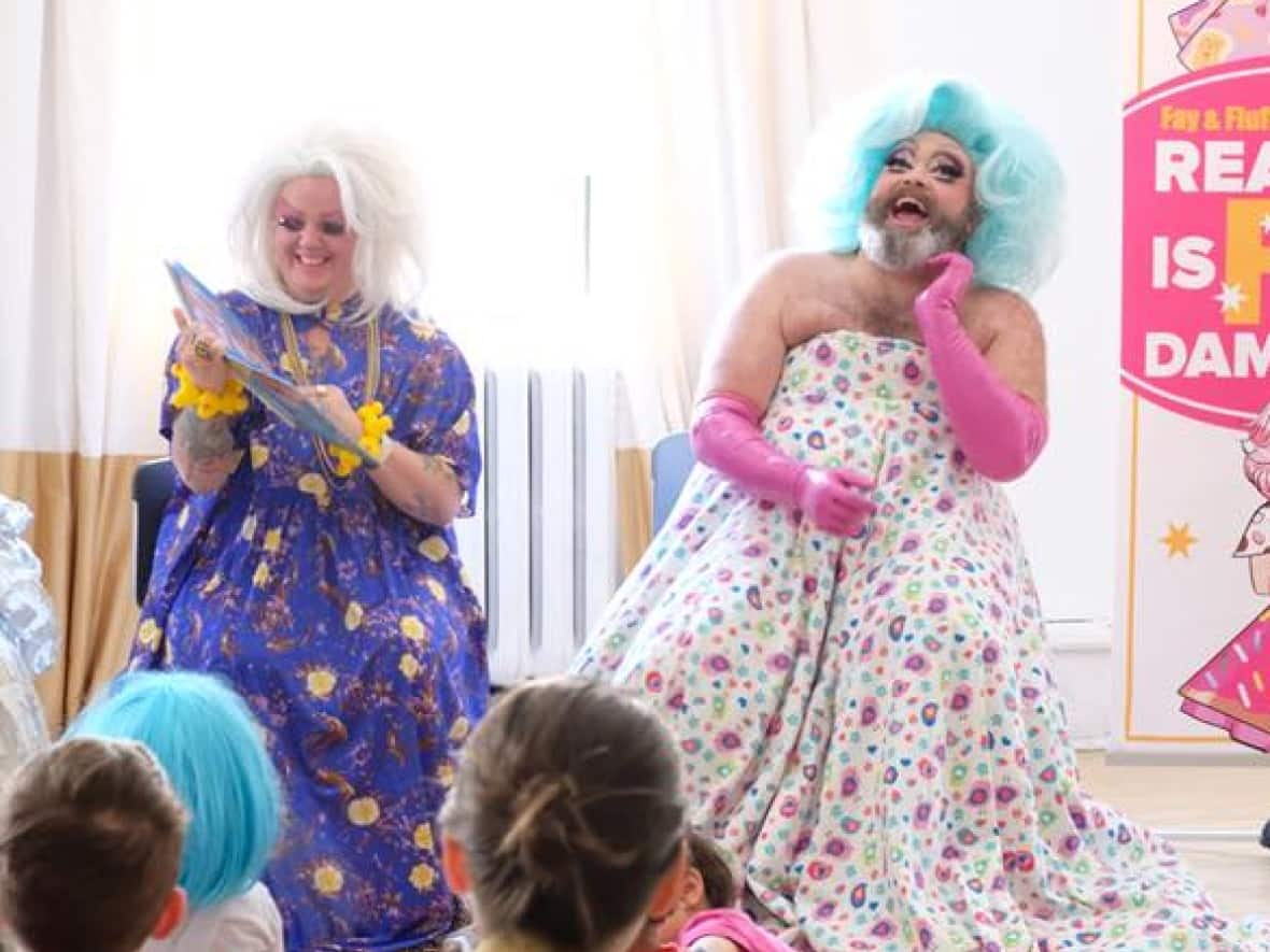 Fay Slift and Fluffy Soufflé perform a drag queen storytime in Toronto. The performers have recently been the target of online threats and hate.  (Fay Slift and Fluffy Soufflé - image credit)