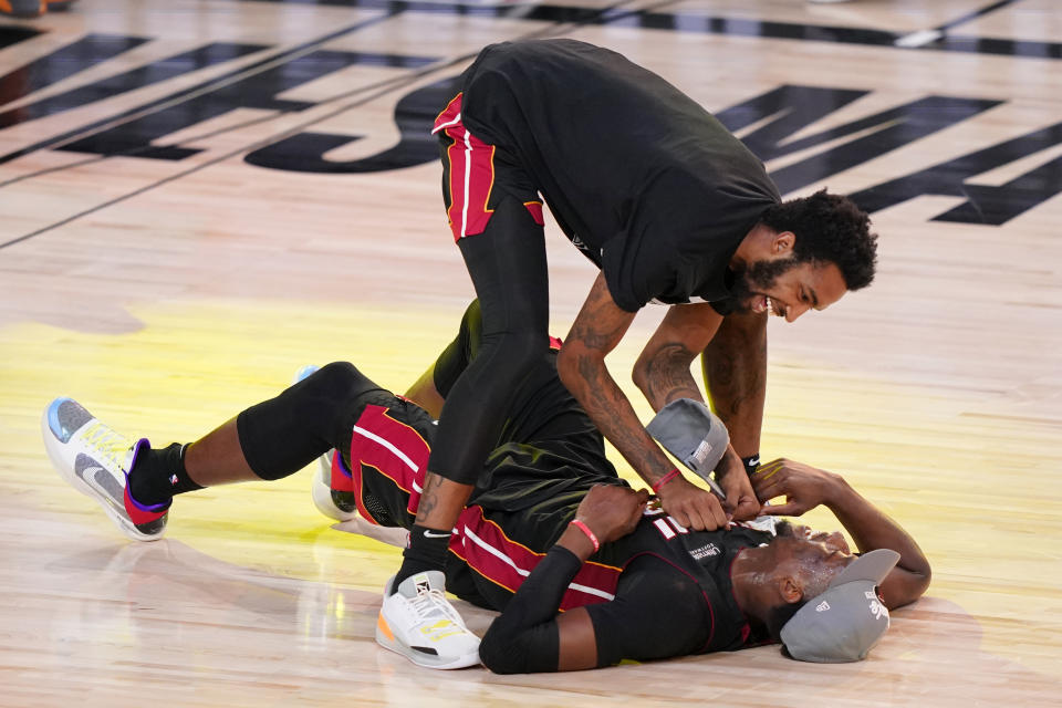 Miami Heat's Bam Adebayo, on the court, celebrates with a teammate after their win over the Boston Celtics in a NBA conference final playoff basketball game Sunday, Sept. 27, 2020, in Lake Buena Vista, Fla. (AP Photo/Mark J. Terrill)