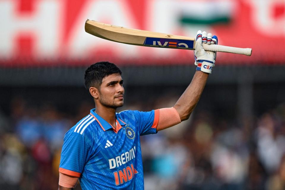 Shubman Gill celebrates after scoring a century (100 runs) during the second one-day international (ODI) cricket match between India and Australia at the Holkar Cricket Stadium in Indore on 24 September (AFP via Getty Images)