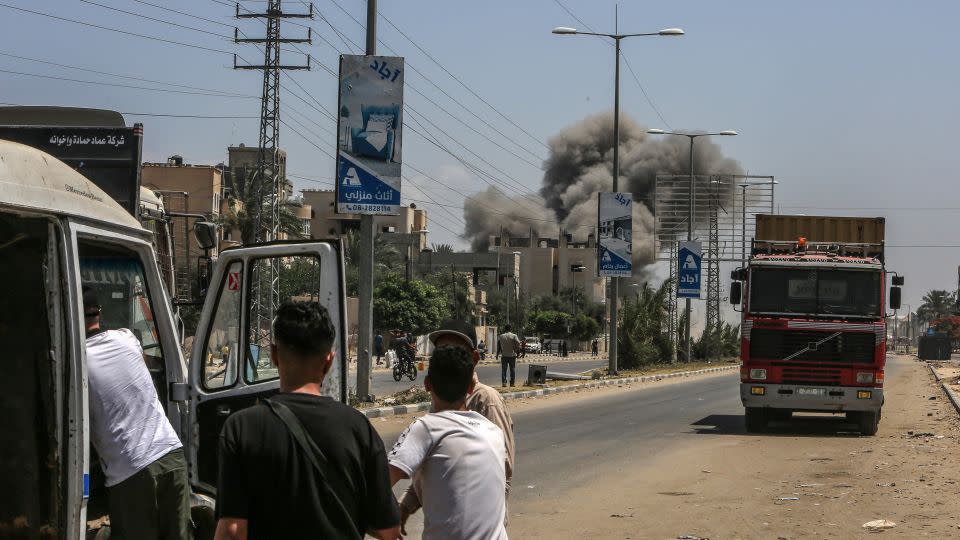 Palestinians watch smoke rising from a residential area following Israeli attacks on Deir al-Balah, Gaza, on June 8, 2024. - Abed Rahim Khatib/Anadolu/Getty Images