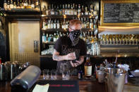 Davey Francis mixes drinks at Velveteen Rabbit, a cocktail bar in the Las Vegas Arts District, on the last night before they will have to close Friday, July 10, 2020, in Las Vegas. Bars in seven Nevada counties were ordered Friday to once again shut their doors and reimpose limits on restaurants because of the coronavirus. (AP Photo/John Locher)